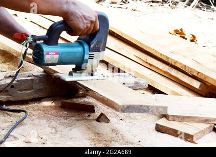 Piano elettrico piano planato uomo. Costruzione, lavorazione del legno Foto Stock