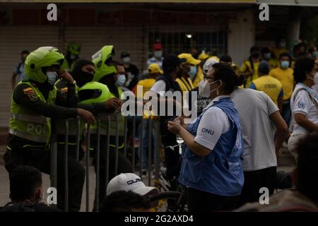 Un membro delle Nazioni Unite guarda ai poliziotti colombiani mentre le squadre colombiane e argentine hanno giocato una partita di qualificazione per la Coppa del mondo FIFA Quatar 2022 allo stadio Metropolitano Roberto Melendez, dimostrazioni intorno allo stadio intensificato a scontri con la polizia colombiana contro disordini e brutalità della polizia, A Barranquilla, Colombia, l'8 giugno 2021. Foto Stock