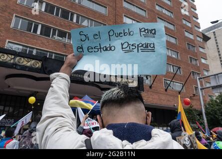 Bogotà, Colombia. 9 giugno 2021. Un dimostratore ha un segno che recita "se il popolo colpisce il governo spara" mentre le manifestazioni hanno preso l'ingresso del Tequendama Hotel durante le riunioni di verifica delle Nazioni Unite e del CIDH in occasione di proteste anti-governative in Colombia che hanno portato ad almeno 70 morti in una protesta di un mese, il 9 giugno, 2021 a Bogotà, Colombia. Credit: Long Visual Press/Alamy Live News Foto Stock