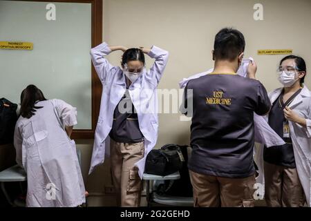 Manila, Filippine. 10 Giugno 2021. Gli studenti di medicina si preparano a frequentare una lezione faccia a faccia all'Università di Santo Tomas. L'università ha iniziato le sue classi faccia a faccia limitate dopo che il governo ha permesso la ripresa della formazione pratica e delle classi di laboratorio nei campus, osservando i protocolli sanitari per prevenire la diffusione della malattia del coronavirus. Foto Stock