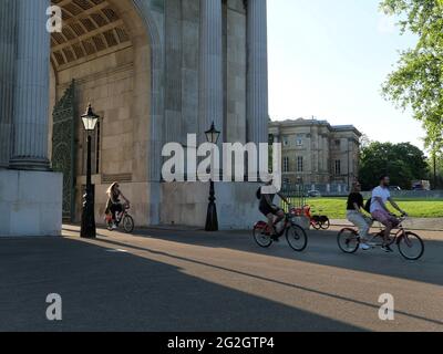 Londra, Grande Londra, Inghilterra - 27 maggio 2021: Ciclisti che escono dal Wellington Arch, alias Constitution Arch, ad Hyde Park Corner Foto Stock