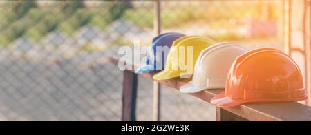 Attrezzature per utensili di sicurezza per elmetto da costruzione per i lavoratori in cantiere per la testa di protezione ingegneristica standard. Molti elmetto elmetto sulla fila wi Foto Stock