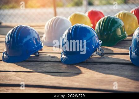 Attrezzature per utensili di sicurezza per elmetto da costruzione per i lavoratori in cantiere per la testa di protezione ingegneristica standard. Molti elmetto elmetto sulla fila wi Foto Stock