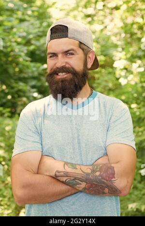 All'esterno c'è il nuovo dentro. Felice uomo bearded sorridente. Ritratto di moda di uomo bearded. Ragazzo maturo in cappello. Allegro viaggiatore hipster. Stare in piedi da soli Foto Stock