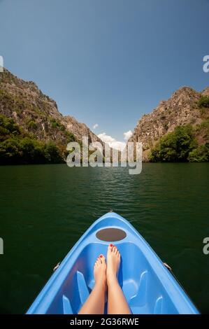 Il kayak attraverso il fiume nel canyon Matka, Macedonia. Donna gambe in kayak blu Foto Stock