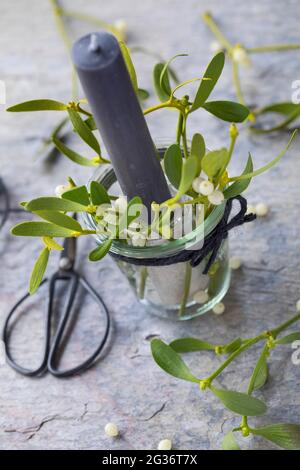 candela con mistletoe come decorazione della tabella Foto Stock