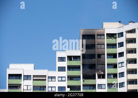 Magonza, Germania. 14 Giugno 2021. La facciata sopra un incendio estinto in un appartamento al 14.o piano di un alto edificio è coperta di fuliggine. Secondo un portavoce della città di Magonza, una persona è stata salvata dall'appartamento. Gli operatori di emergenza hanno parzialmente evacuato l'edificio a 18 piani di Magonza-Gonsenheim. Inizialmente non era noto perché l'incendio scoppiasse. Credit: Sebastian Gollnow/dpa/Alamy Live News Foto Stock