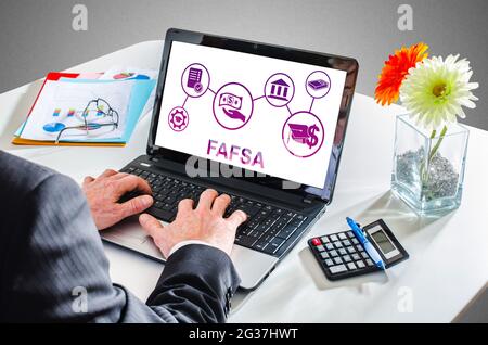 Uomo che scrive su un computer portatile mostrando un concetto di fafsa Foto Stock