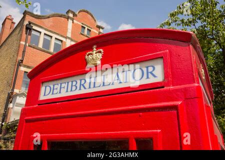 Primo piano della segnaletica su un defibrillatore ad accesso pubblico conservato in una scatola del telefono di Londra riutilizzata Foto Stock