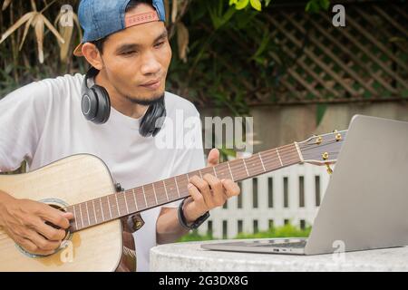 Ragazzo che suona la chitarra all'hom Foto Stock