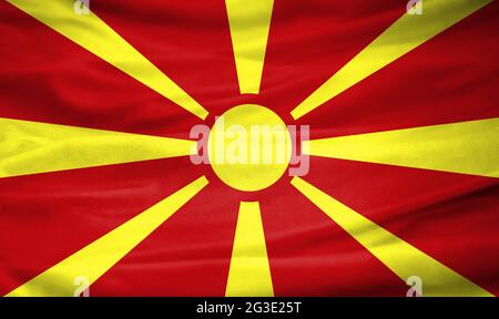 Bandiera realistica di Macedonia sulla superficie ondulata di tessuto Foto Stock