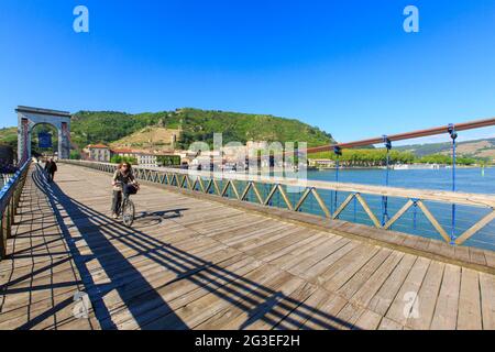 FRANCIA. ARDECHE (07) TAIN L'HERMITAGE UNE DONNA CON BICICLETTA SUL PONTE MARC SEGUIN Foto Stock