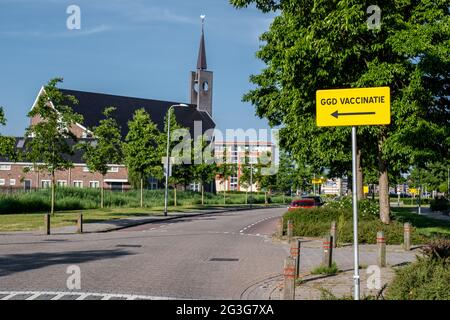 Urk Flevoland Paesi Bassi 2021 giugno, segno che punta verso una struttura di vaccinazione Corona o Covid-19. Traduzione dei segni: Vaccinazioni GGD Istituto nazionale olandese di sanità pubblica. Paesi Bassi Foto Stock