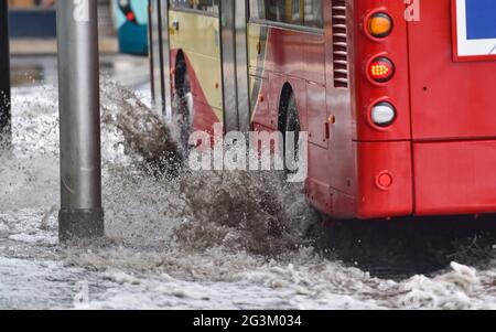 Brighton UK 17 giugno 2021 - autobus guidare attraverso le acque alluvionali sulle strade a Valley Gardens a Brighton dopo una notte di pioggia pesante e tempeste tuose nel Sud Est : Credit Simon Dack / Alamy Live News Foto Stock