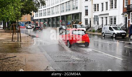 Brighton UK 17 giugno 2021 - le automobili guidano attraverso l'acqua di inondazione sulle strade a Valley Gardens in Brighton dopo una notte di pioggia pesante e tempeste di tuono nel sud-est: Credit Simon Dack / Alamy Live News Foto Stock