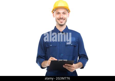 Orizzontale medio ritratto di successo bel giovane adulto caucasico costruzione ingegnere indossando uniforme tenendo appunti con carte Foto Stock