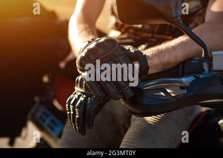 Vista ravvicinata sul ciclista le mani in un paio di guanti in cuoio Foto Stock