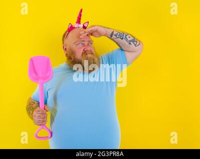 fat uomo con archetto gioco con paddle mare Foto Stock