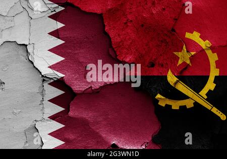 Bandiere del Qatar e dell'Angola dipinte su pareti incrinate Foto Stock