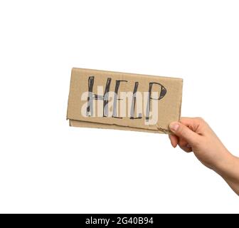 La mano tiene un pezzo di cartone con l'iscrizione aiuto, concetto di mutua assistenza Foto Stock