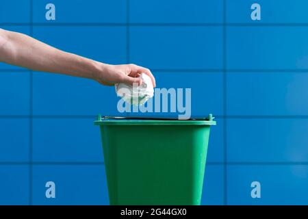 gettare a mano il pezzo di carta sgualcito nel cestino Foto Stock