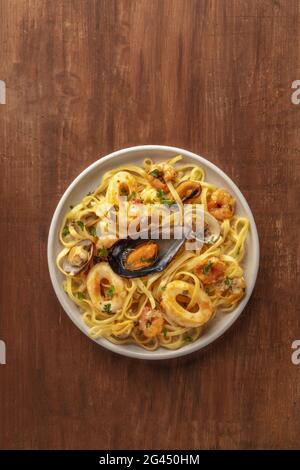 Pasta di pesce. Una foto in alto di un piatto di tagliolini con cozze, gamberetti, ecc. Foto Stock
