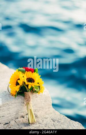 Matrimonio bouquet nuziale di girasoli sul molo vicino al mare. W Foto Stock