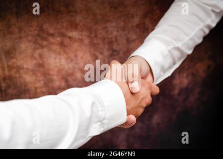 Uomini d'affari aziendali Handshake Indoors.Two persone professionalmente ben vestito gesturing togetherness.Working colleghi Partners Foto Stock