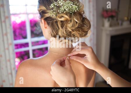 Catena di fissaggio della bridesmaid nello spogliatoio Foto Stock