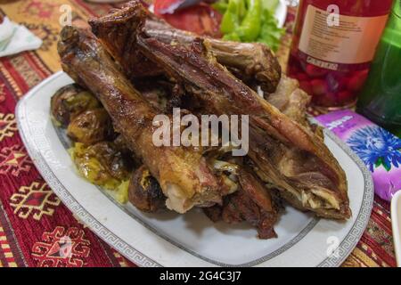 Deliziosa gamba di agnello arrosto sul piatto. Cucina Azerbaigian Foto Stock