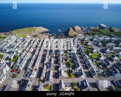 Vista aerea dal drone di file di case nell'ex villaggio di pescatori di Portknockie sulla costa di Moray Firth a Moray, Scozia, Regno Unito Foto Stock