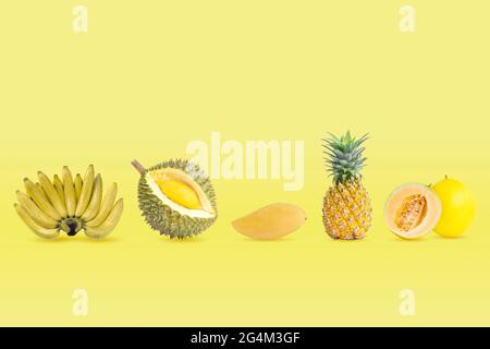 Raccolta di frutti di colore giallo isolati su sfondo di colori pastello gialli. Foto Stock