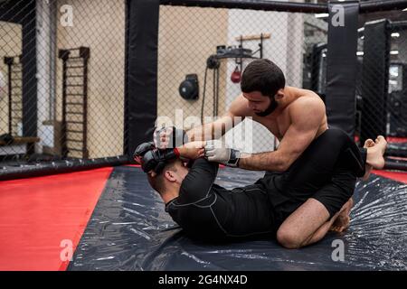 MMA. Due pugili professionisti pugilato, in forma muscolare caucasica atleti in lotta. Concetto di sport, competizione, eccitazione ed emozioni umane Foto Stock