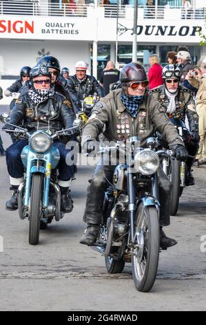 Motociclisti in vintage abbigliamento motociclistico che cavalcano moto classiche al Goodwood Revival 2011, UK. Cavalcare in pelle nera retrò, vecchie biciclette Foto Stock