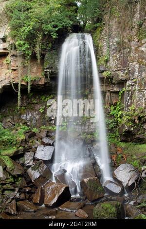 Le cascate di Melincourt, Neath, Galles, hanno preso con una velocità di scatto lenta per mostrare il movimento dell'acqua mentre cade giù sulle rocce Foto Stock