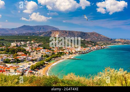 Vacanze greche, Kalyves bellissimo villaggio con il mare turchese in Creta, Grecia. Vista della spiaggia Kalyves, Creta. Gabbiani sorvolano la spiaggia in Foto Stock