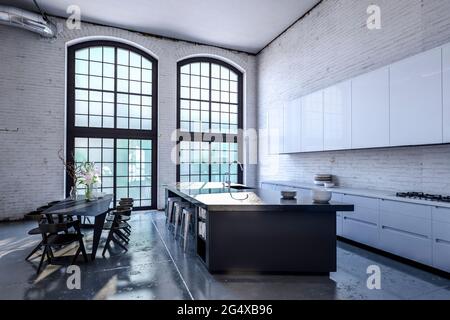 Isola cucina e tavolo da pranzo in casa moderna Foto Stock