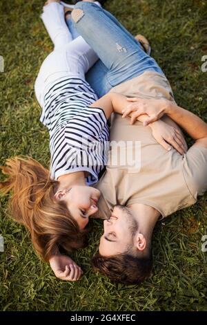 Coppia romanting mentre si sdraiano sul prato Foto Stock