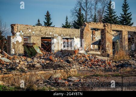 Vista della vecchia casa in mattoni rovinati. Rovine di edifici abbandonati. Foto Stock