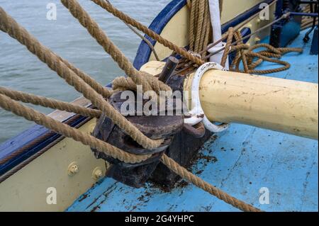 Un cavallo con un grande blocco di puleggia sulla storica chiatta a vela 'Edith May' che si muove liberamente da un lato all'altro quando si infila. Estuario del Tamigi, Kent, Regno Unito. Foto Stock