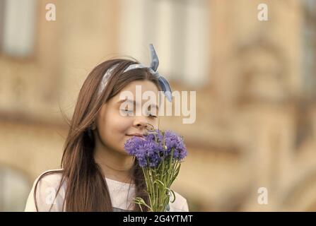 Profumo e cura. Piccolo bambino sniff estate fiori all'aperto. Allergia al polline e febbre da fieno. Prodotti per la cura della pelle. Cosmetici sicuri. Assistenza all'infanzia. Pediatrico Foto Stock