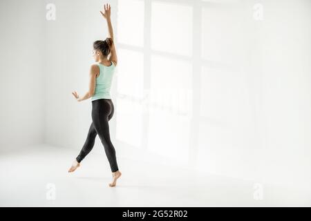 Donna che pratica ginnastica ritmica da sola Foto Stock