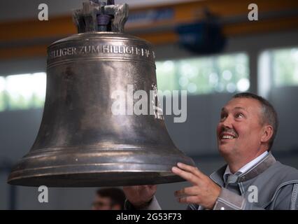 Freiberg, Germania. 25 2021 giugno: Volker Haupt, presidente della Hiliger Verein, si trova nella Sächsische Metallwerke Freiberg in una campana che è stata gettata come campione per un esemplare più grande destinato alla Cattedrale di Merseburg. L'occasione per il lancio della campana è il 1000° anniversario della consacrazione della cattedrale di quest'anno. La campana peserà 890 chilogrammi e suonerà in un unico G. il tono si armonizzerà con le altre campane della cattedrale. Il tono si armonizza con le due grandi campane della chiesa. La campana sarà consacrata il 1° ottobre. Credit: dpa Picture Alliance/Alamy Live News Foto Stock