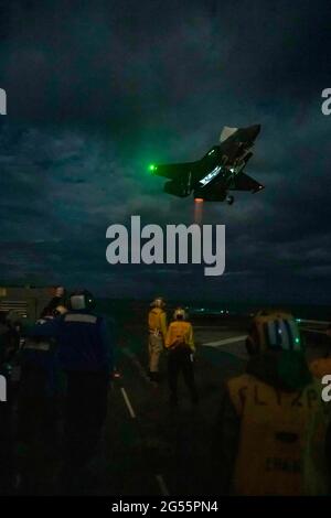 USA America, Giappone. 24 Giugno 2021. Un aereo da combattimento US Marine Corps F-35B Lighting II della 31esima unità di spedizione marina, effettua un atterraggio notturno sul ponte di volo della nave d'assalto anfibia USS America 24 giugno 2021 nel Mare della Cina orientale. Credit: Planetpix/Alamy Live News Foto Stock