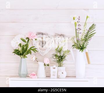 Festoso e romantico bouquet di peonie bianche e rosa su un muro di legno bianco sfondo, stile scandinavo. Sfondo del matrimonio Foto Stock