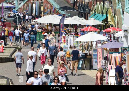 Brighton, Regno Unito. 26 giugno 2021. I visitatori godono del sole caldo sulla spiaggia di Brighton e sul lungomare, ma il tempo più instabile è previsto per i prossimi giorni nel Regno Unito: Credit Simon Dack / Alamy Live News Foto Stock