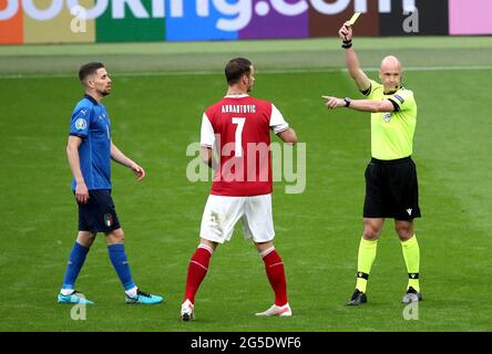 L'arbitro Anthony Taylor (a destra) mostra una carta gialla al Marko Arnautovic austriaco durante la partita UEFA Euro 2020 del 16 tenutasi al Wembley Stadium di Londra. Data immagine: Sabato 26 giugno 2021. Foto Stock