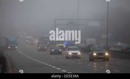 Guida di un'auto in cattive condizioni meteorologiche, giorno nebbioso sulla strada Foto Stock