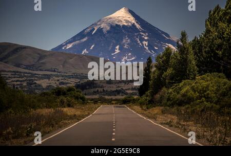 Strada in Patagonia Argentina. Sullo sfondo il famoso Volcán Lanín (Vulcano Lanín) che dà il nome al Parco Nazionale Lanín, Patagonia Argentina Foto Stock