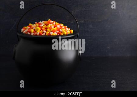 Cauldron nero per streghe piene di granoturco caramello Foto Stock